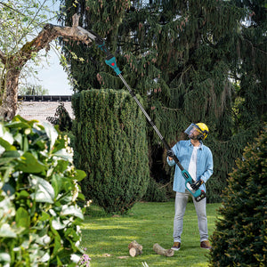 Person using a string trimmer to trim bushes in a garden